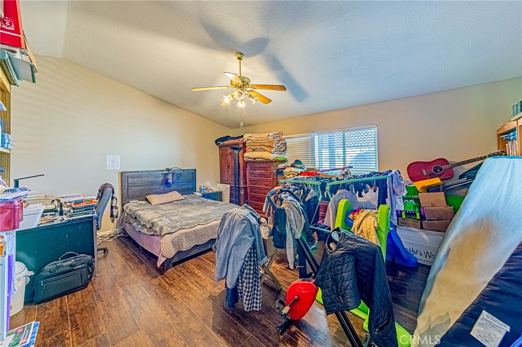 9922 Phelan Road Oak Hills, CA 92344 - Photo 13 of 30 a bedroom with furniture and a bed