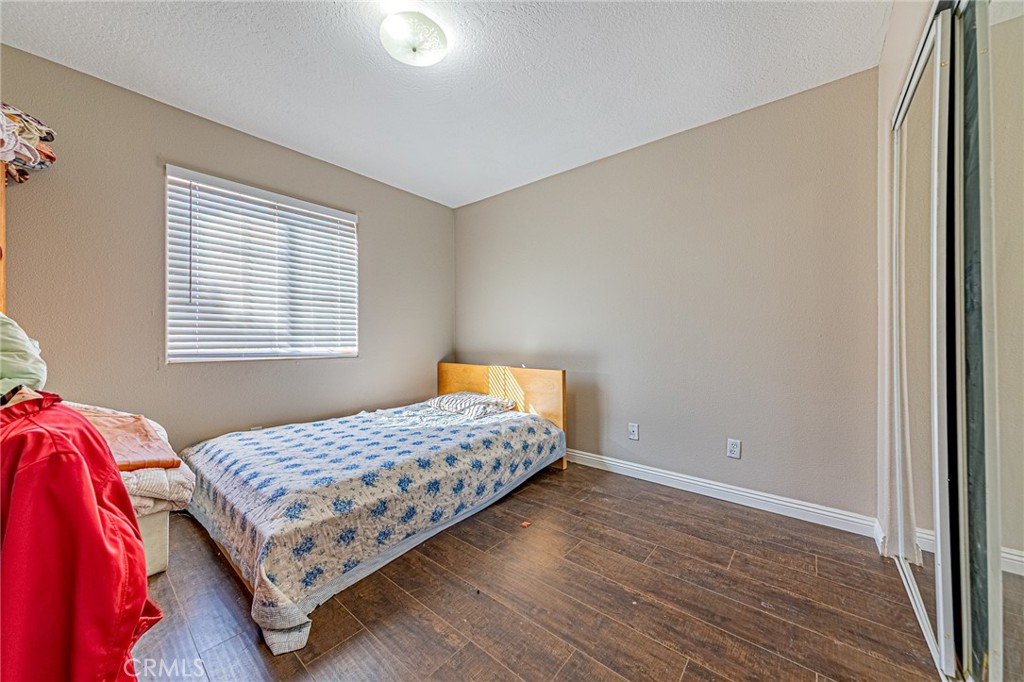 9922 Phelan Road Oak Hills, CA 92344 - Photo 17 of 30 a bedroom with a bed and a window