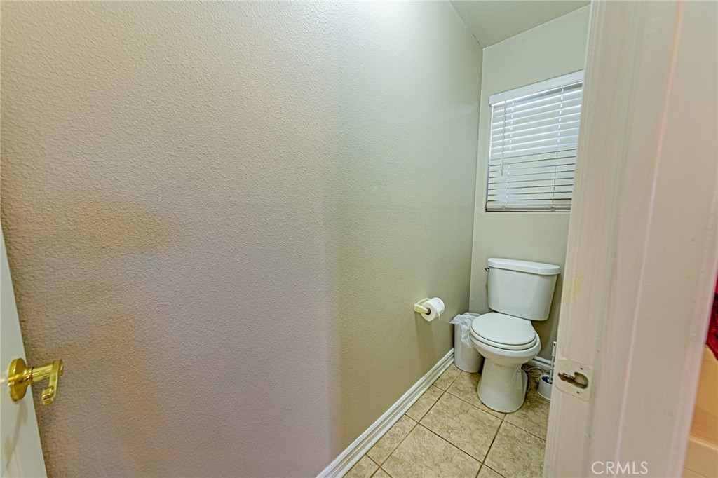 9922 Phelan Road Oak Hills, CA 92344 - Photo 18 of 30 a white toilet sitting next to a white sink