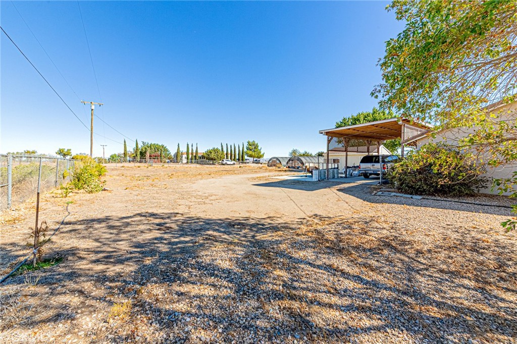 9922 Phelan Road Oak Hills, CA 92344 - Photo 26 of 30 a view of a lake with a lawn chairs and large trees