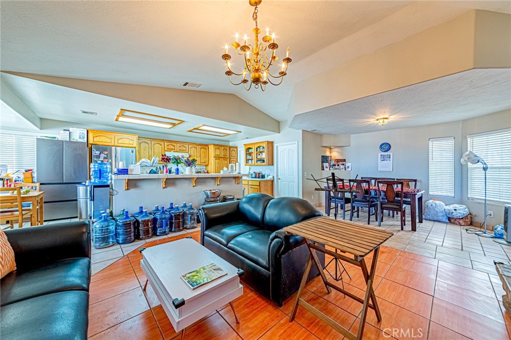 9922 Phelan Road Oak Hills, CA 92344 - Photo 5 of 30 a living room with lots of furniture and a chandelier