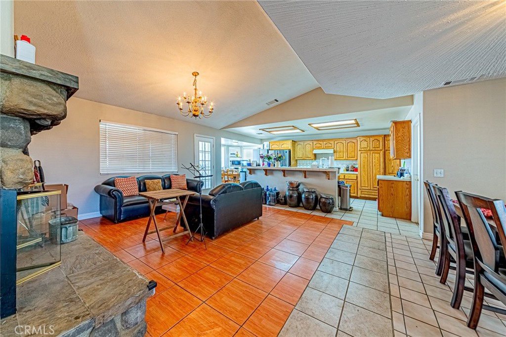 9922 Phelan Road Oak Hills, CA 92344 - Photo 7 of 30 a living room with furniture a dining table and a large window