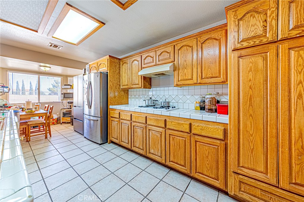 9922 Phelan Road Oak Hills, CA 92344 - Photo 8 of 30 a spacious bathroom with a granite countertop sink and a large window