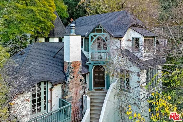 a aerial view of a house with a yard and balcony