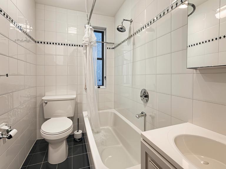 425 Riverside Drive, Unit 6D Manhattan, NY 10025 - Photo 5 of 14 a bathroom with a sink a toilet and a bathtub