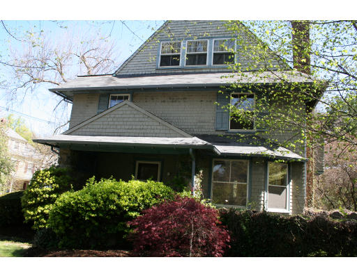 125 Middlesex Road Brookline, MA 02467 - Photo 3 of 8 a view of a house with potted plants and a table and chairs