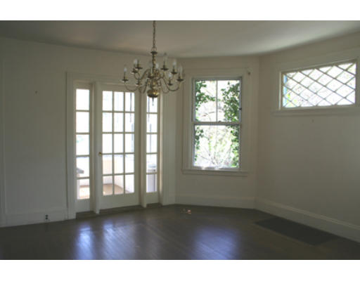 125 Middlesex Road Brookline, MA 02467 - Photo 7 of 8 a view of an empty room with wooden floor and chandelier
