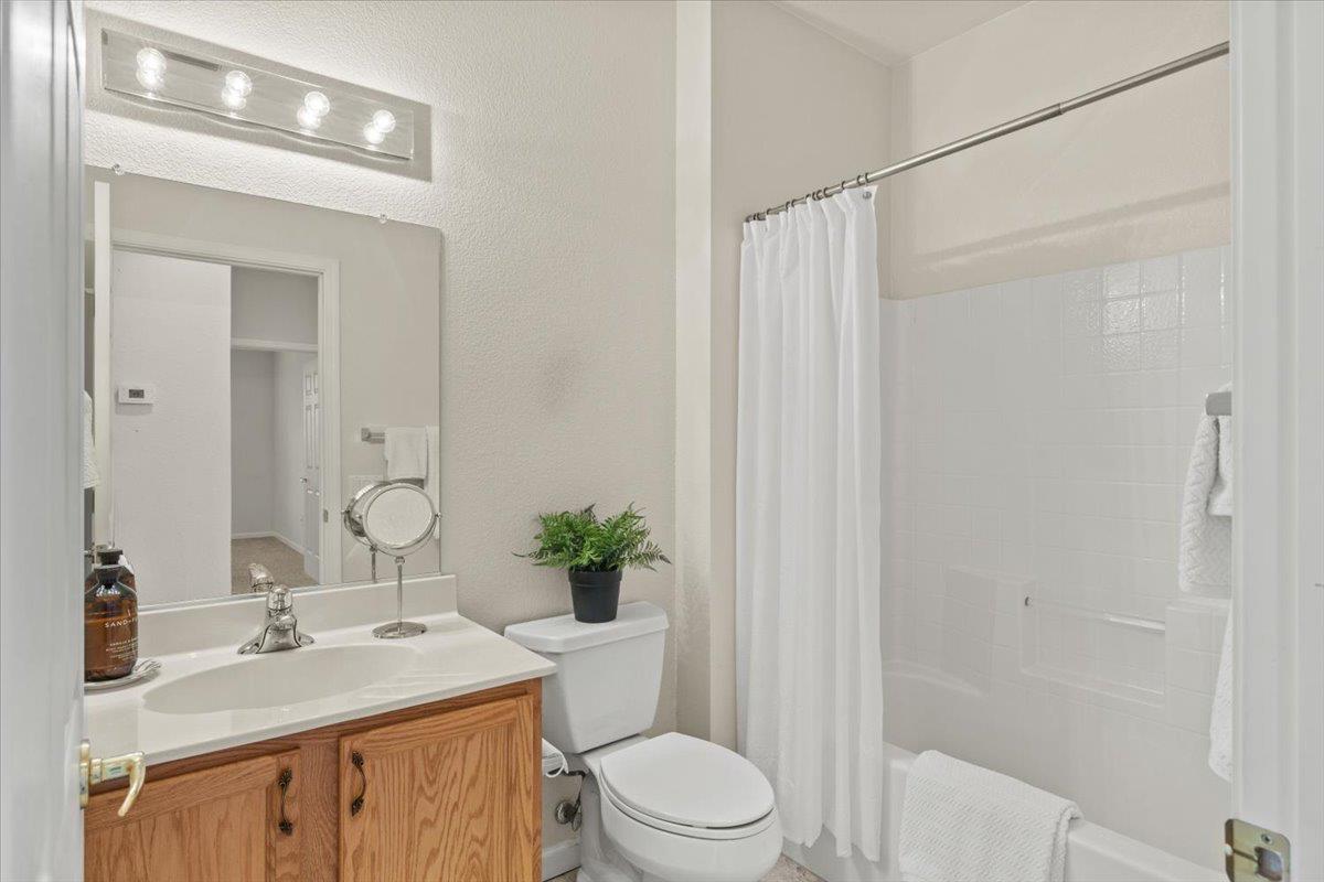 596 Geary Lane Lincoln, CA 95648 - Photo 20 of 27 a bathroom with a granite countertop sink a toilet and shower