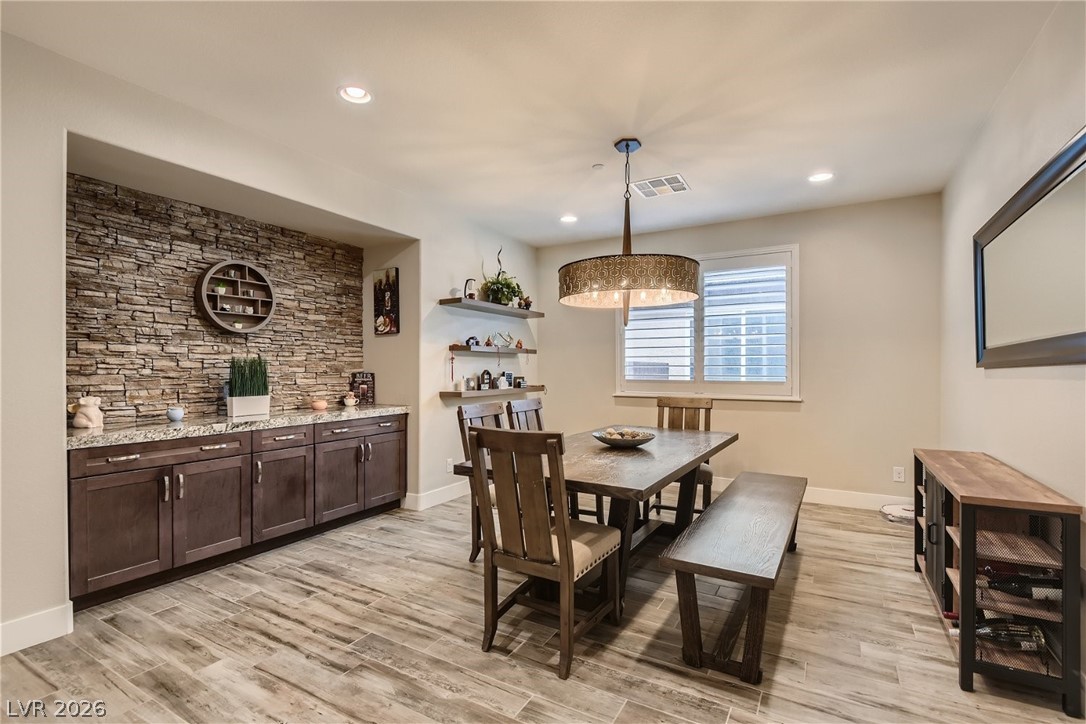 4631 Amazing View Street Las Vegas, NV 89129 - Photo 7 of 33 Textured stone accent wall provides visual interest and a sophisticated touch to this dining area.
