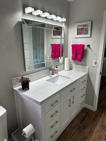 a bathroom with a sink vanity and a mirror