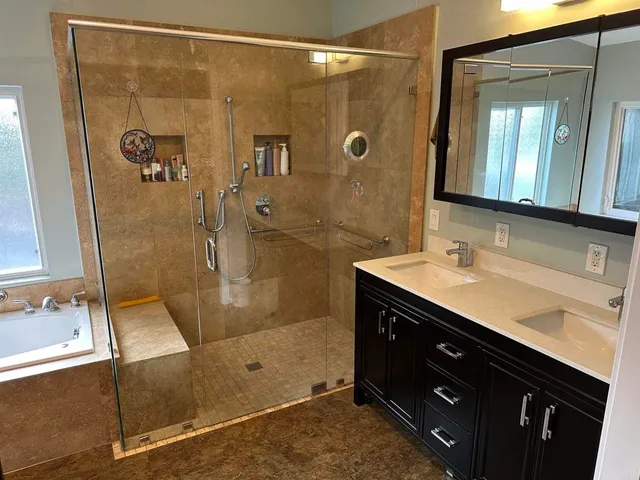a bathroom with a shower sink and mirror
