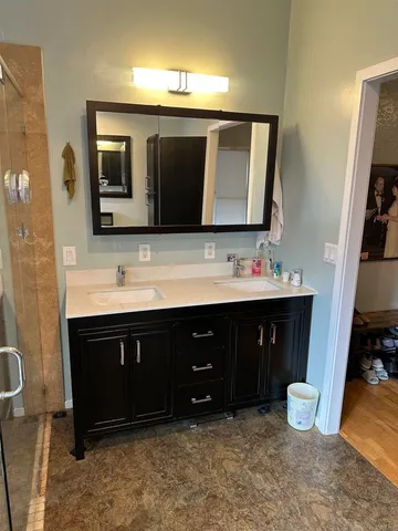 a bathroom with a sink vanity and a mirror