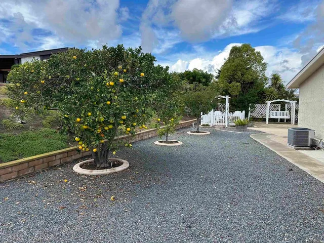 a view of a house with backyard porch and sitting area