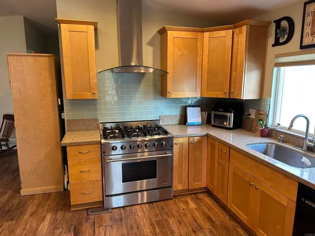 a kitchen with a stove a sink and a refrigerator