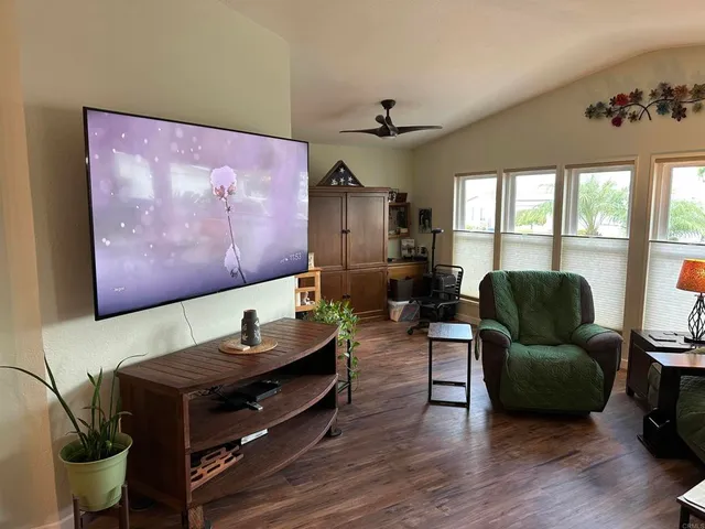 a living room with furniture and wooden floor