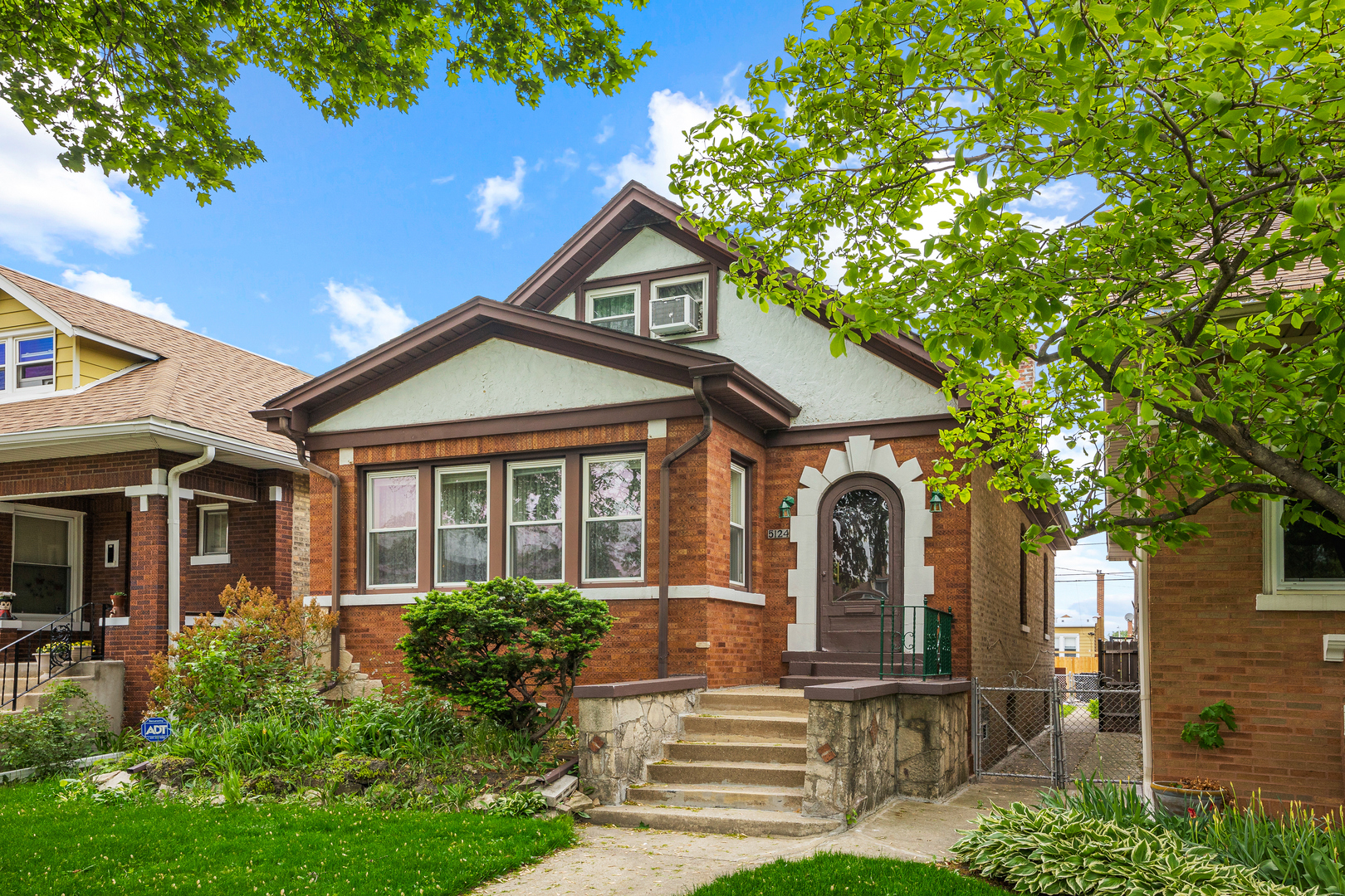5124 West Nelson Street Chicago, IL 60641 - Photo 1 of 21 a front view of a house with garden