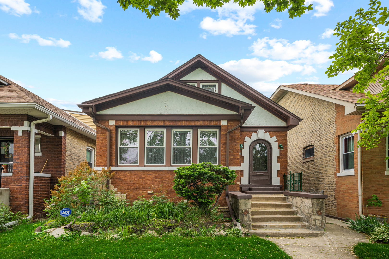 5124 West Nelson Street Chicago, IL 60641 - Photo 2 of 21 a front view of a house with a yard