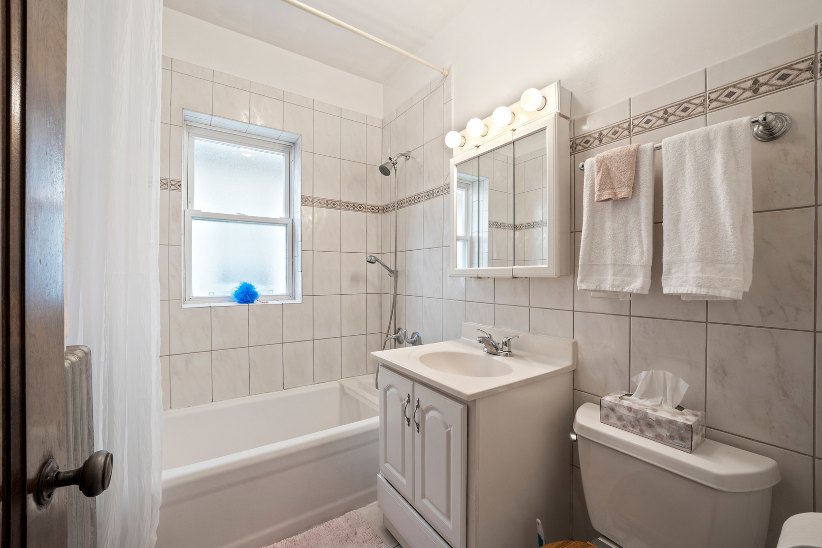 5124 West Nelson Street Chicago, IL 60641 - Photo 8 of 21 a bathroom with a sink a toilet and shower