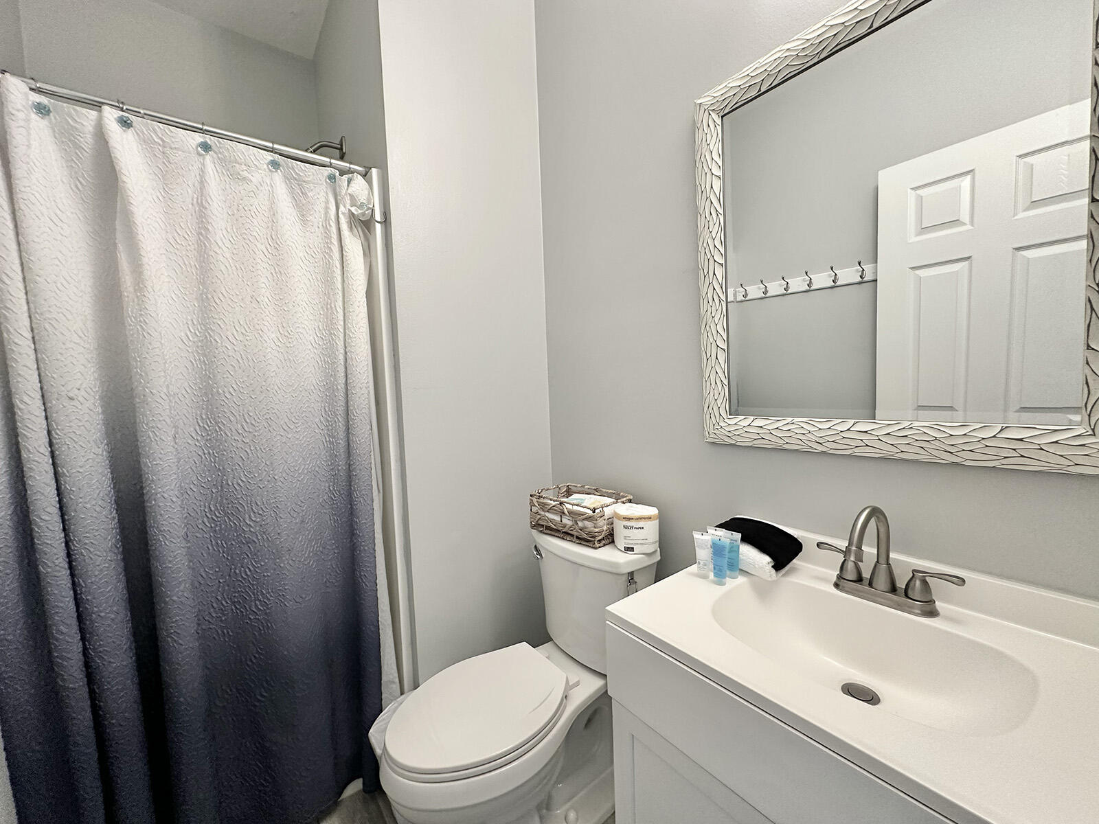 83 Sunfish Street Destin, FL 32541 - Photo 43 of 56 a bathroom with a sink a toilet and shower curtain