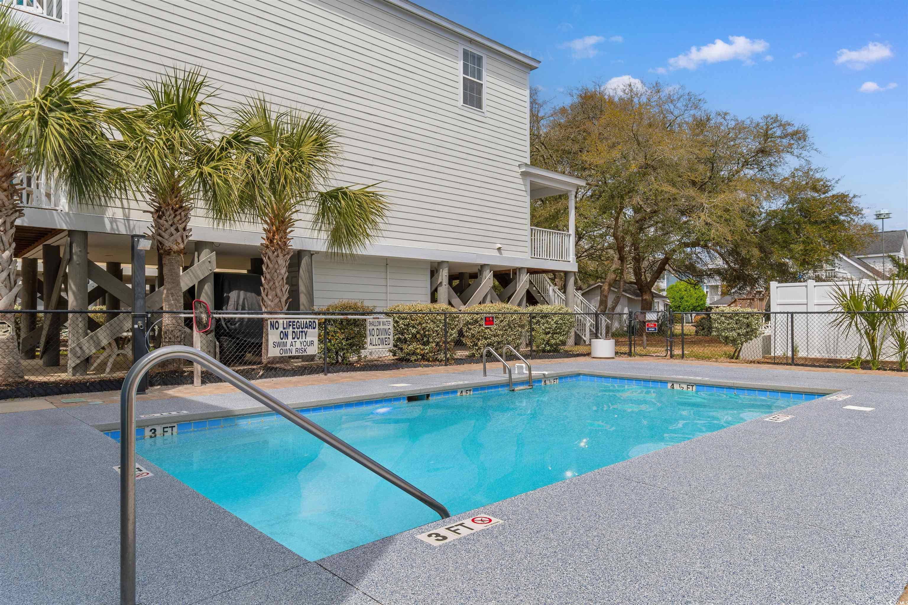 808 North Ocean Boulevard Surfside Beach, SC 29575 - Photo 10 of 39 Community pool featuring fence and a patio area