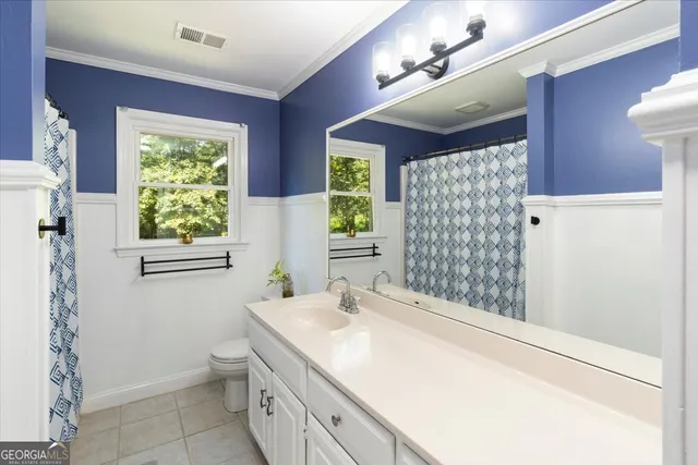a living room with furniture and a book shelf