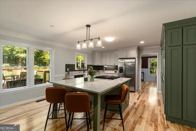a kitchen with a stove top oven and refrigerator