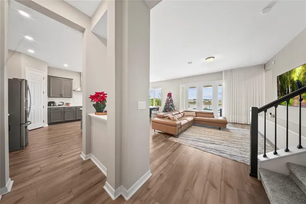 a dining room with furniture a chandelier and wooden floor