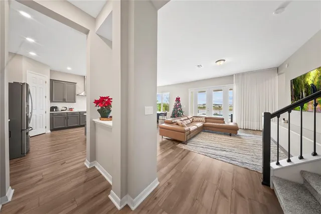 a dining room with furniture a chandelier and wooden floor
