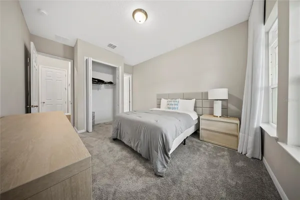 a view of an empty room with wooden floor and windows