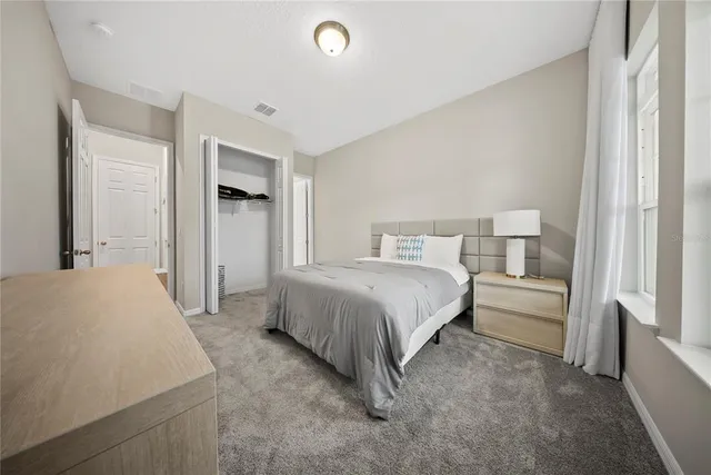 a view of an empty room with wooden floor and windows