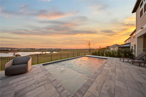 a view of swimming pool with outdoor seating