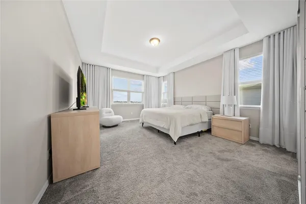 a bedroom with bed and a couch