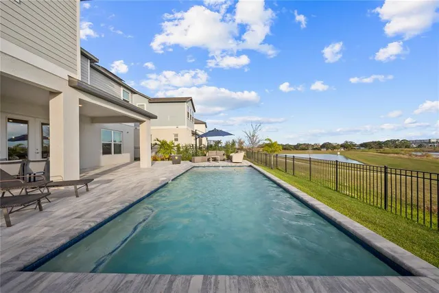 a view of a dining room with furniture and a floor to ceiling window