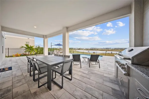 a kitchen with stainless steel appliances granite countertop a stove a sink dishwasher and a microwave oven with wooden floor
