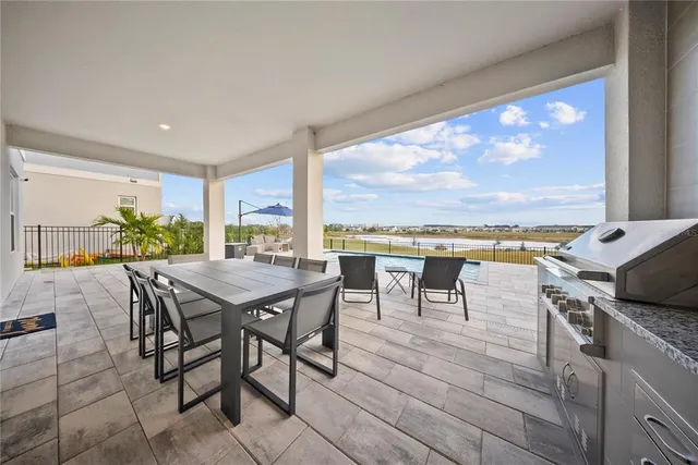 a kitchen with stainless steel appliances granite countertop a stove a sink dishwasher and a microwave oven with wooden floor