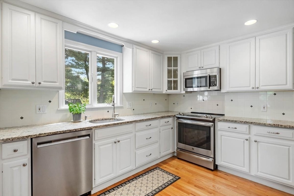 60 Old County Road Hingham, MA 02043 - Photo 11 of 32 a kitchen with stainless steel appliances granite countertop a sink a stove a microwave and cabinets