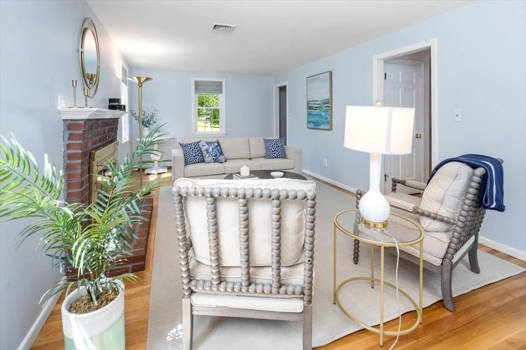 60 Old County Road Hingham, MA 02043 - Photo 15 of 32 a living room with furniture a potted plant and a fireplace