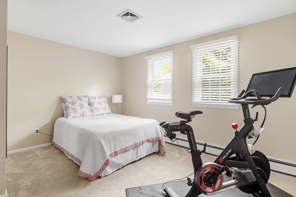 60 Old County Road Hingham, MA 02043 - Photo 23 of 32 a bedroom with a bed a desk and chair with wooden floor