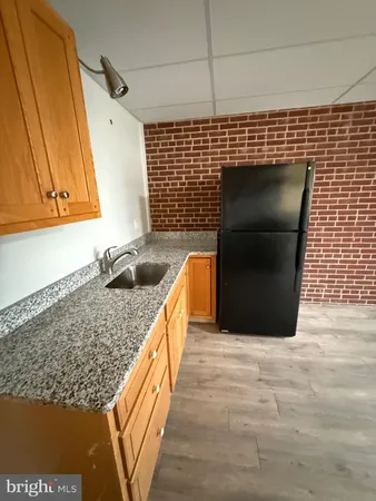 a kitchen with a sink and a refrigerator