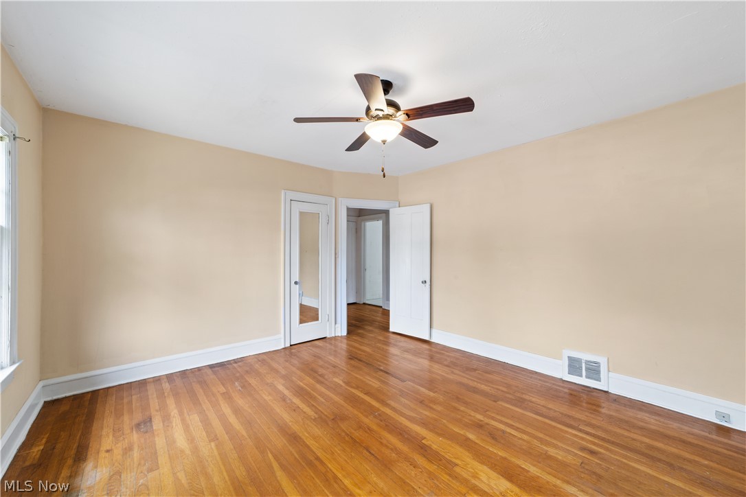 3076 Yorkshire Road Cleveland, OH 44118 - Photo 17 of 47 Empty room featuring ceiling fan and wood-type flooring