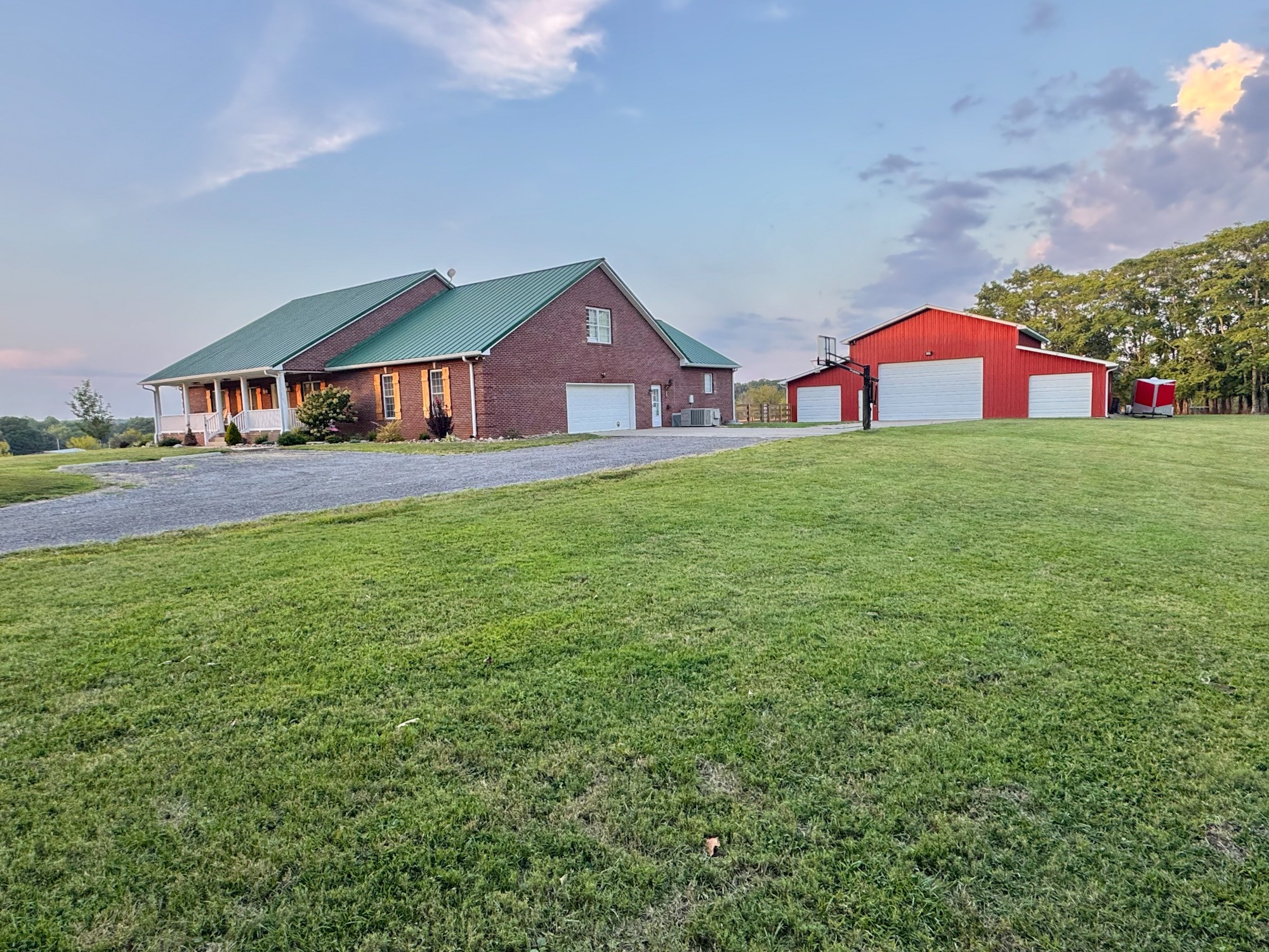 a front view of a house with a garden and yard