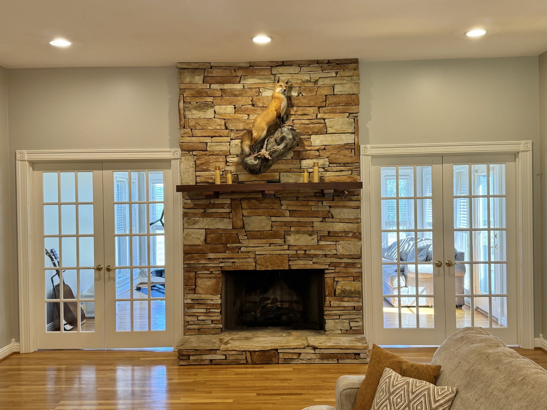 399 Edgar Meeks Road Burns, TN 37029 - Photo 14 of 28 a living room with a fireplace and a floor to ceiling window
