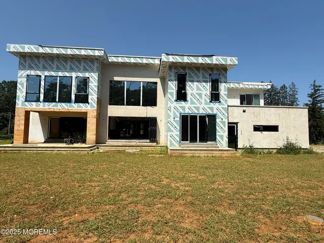 a house view with swimming pool in front of it
