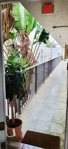 a balcony with outdoor seating and city view
