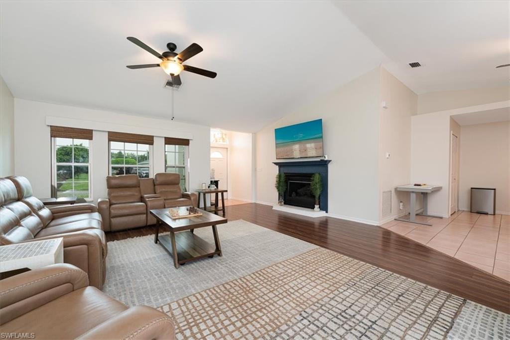 8312 Tahiti Road Fort Myers, FL 33967 - Photo 8 of 43 Bright Spacious Living Room with Fireplace & Sliders that open to the Pool Lanai area.
