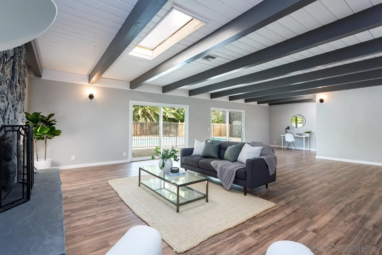 a living room with furniture and a potted plant