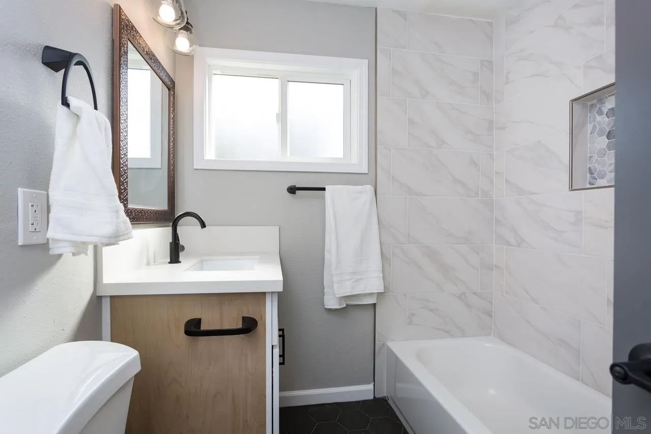 9597 Mandeville Road Santee, CA 92071 - Photo 19 of 32 a bathroom with a sink toilet and tub
