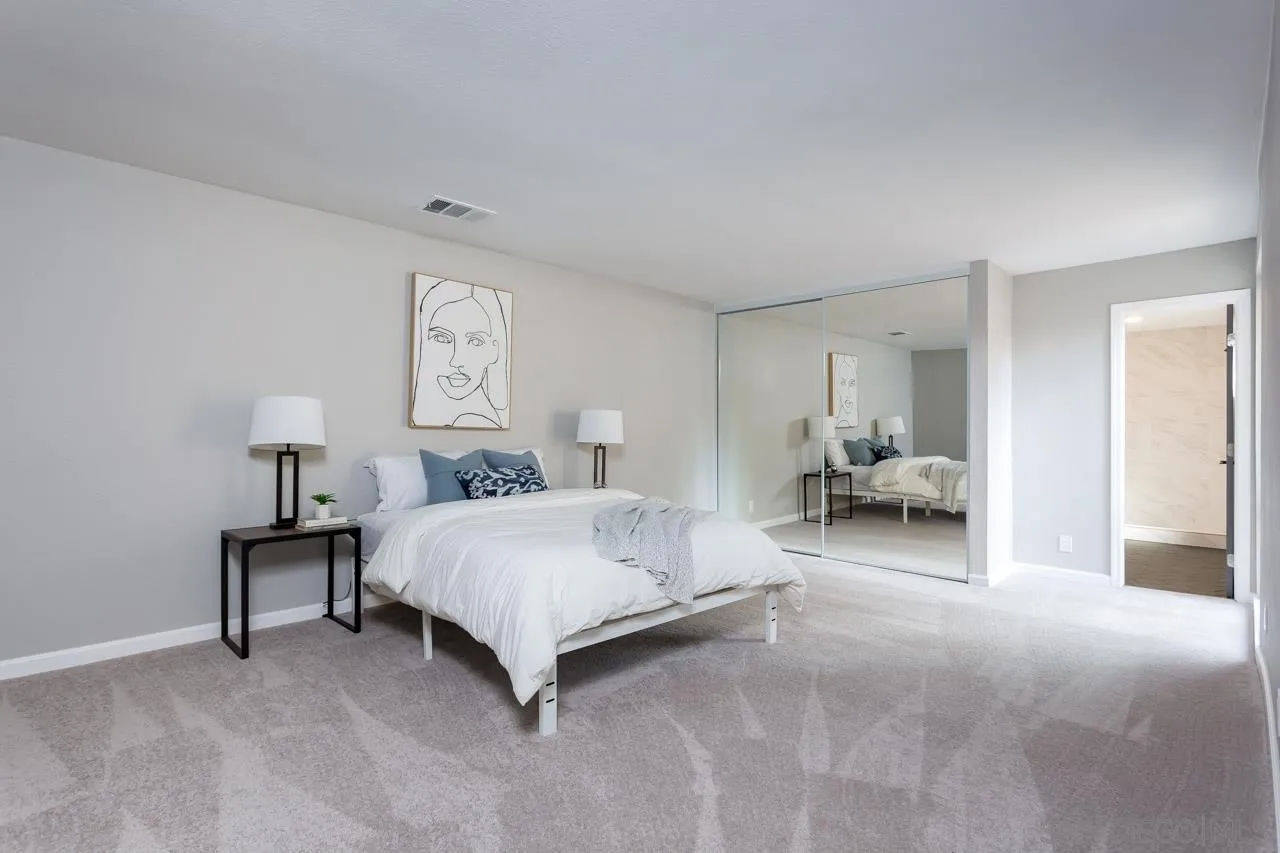 9597 Mandeville Road Santee, CA 92071 - Photo 22 of 32 a spacious bedroom with a bed and a lamp