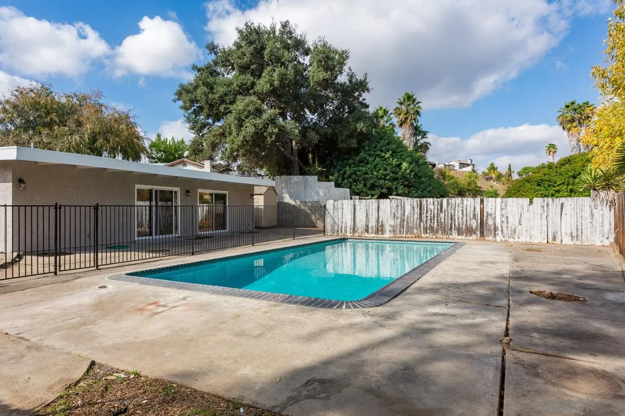 9597 Mandeville Road Santee, CA 92071 - Photo 28 of 32 a view of a backyard with a barbeque and fence
