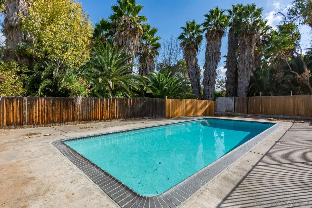 9597 Mandeville Road Santee, CA 92071 - Photo 29 of 32 a view of a backyard with a large tree and wooden fence